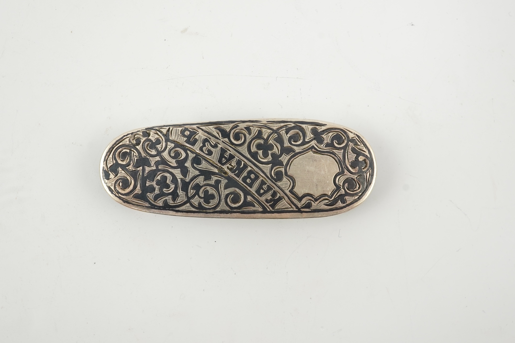 A 19th century Russian silver and niello coin case, of oval form, with Cyrillic inscription and three slide action coin compartments, unknown master, 76mm.